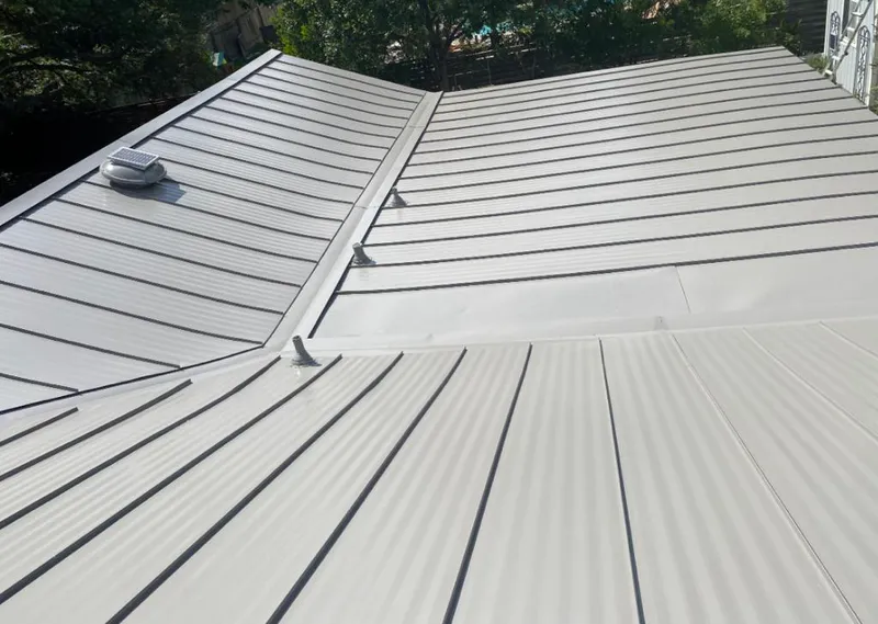 Solar attic fan installed on a metal roof for Roof Ventilation in Fort Smith